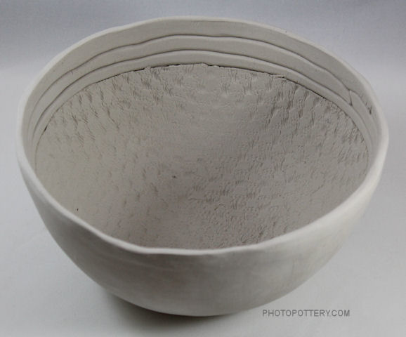 Made on plaster hump bowl mold with clay slab and coils, this pottery bowl is both functional and decorative. Stoneware clay, greenware. (Sample)