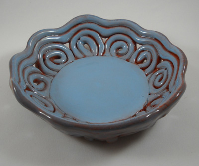 Decorative ceramic bowl made on round plaster drape mold. Sample is in earthenware, slab combined with coils. 